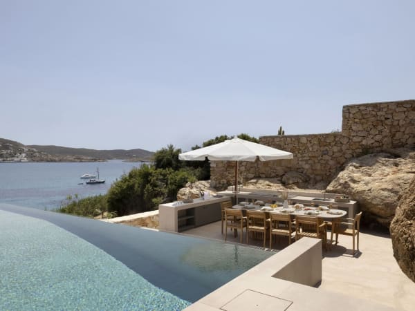 The secluded al fresco dining area and kitchen seen from the pool terrace.